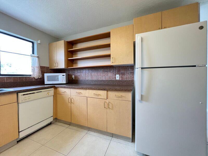 10225 Northwest 33rd Street Sunrise, FL 33351 - Photo 13 of 51 a white refrigerator freezer sitting inside of a kitchen