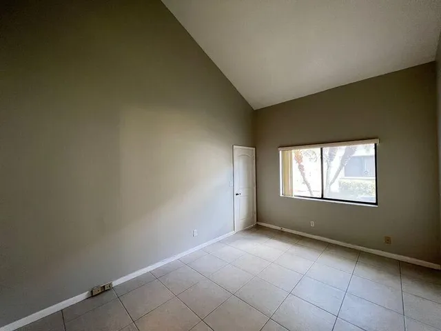 an empty room with a empty space and windows