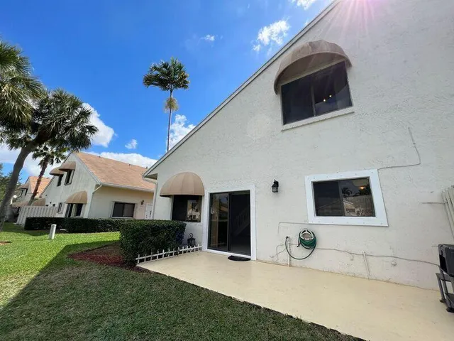 a view of a patio with table and chairs with wooden floor and fence