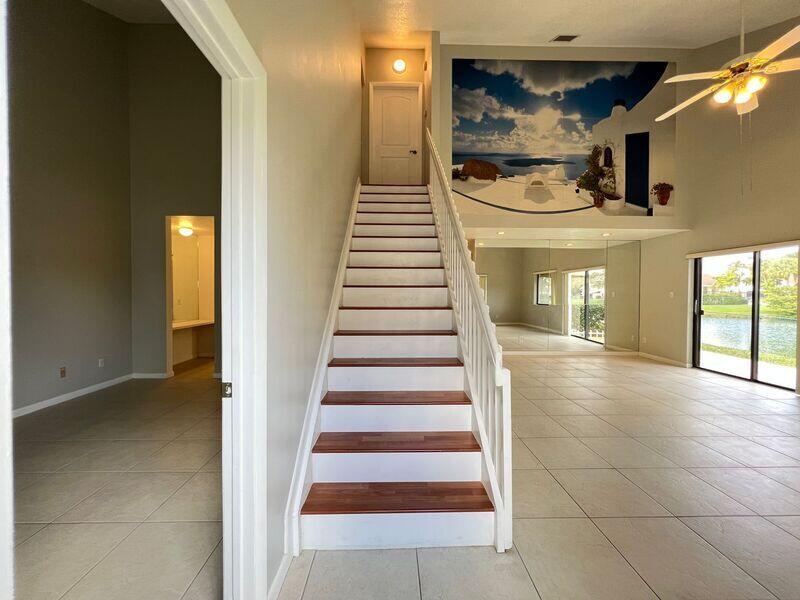 10225 Northwest 33rd Street Sunrise, FL 33351 - Photo 3 of 51 a view of a hallway with entryway and chandelier