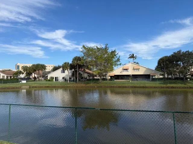 an aerial view of residential houses with outdoor space and lake view