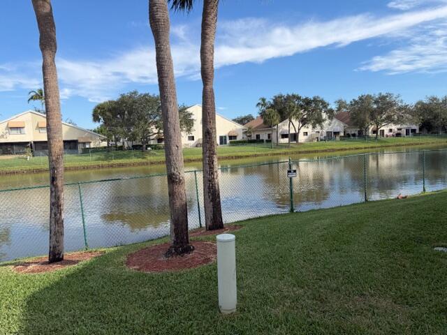 10225 Northwest 33rd Street Sunrise, FL 33351 - Photo 43 of 51 a view of a lake with a big yard and palm trees
