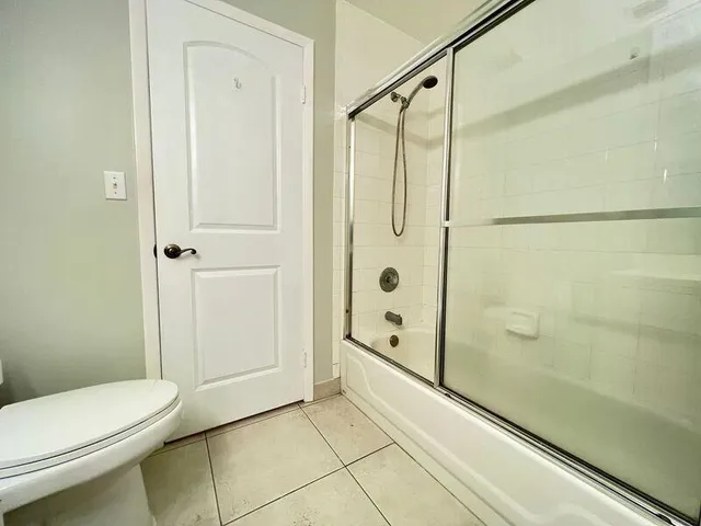 a bathroom with a shower and a toilet