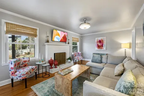 a living room with furniture kitchen view and a fireplace