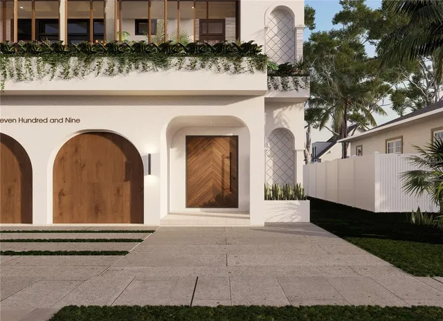 a front view of a house with plants