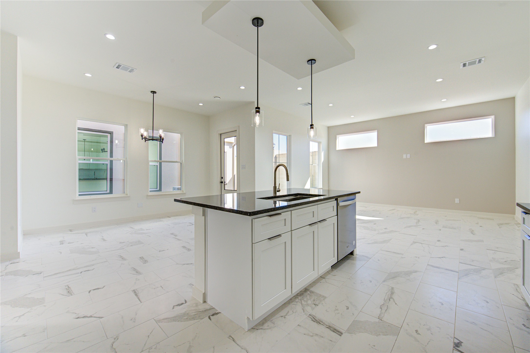 2931 El Fenice Lane Houston, TX 77057 - Photo 13 of 46 a large kitchen with kitchen island a sink a counter stainless steel appliances and cabinets