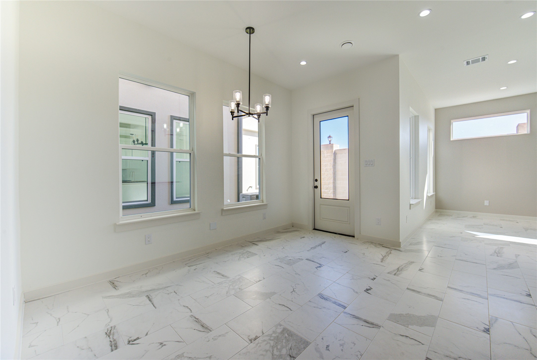 2931 El Fenice Lane Houston, TX 77057 - Photo 14 of 46 a view of an empty room with chandelier and glass door