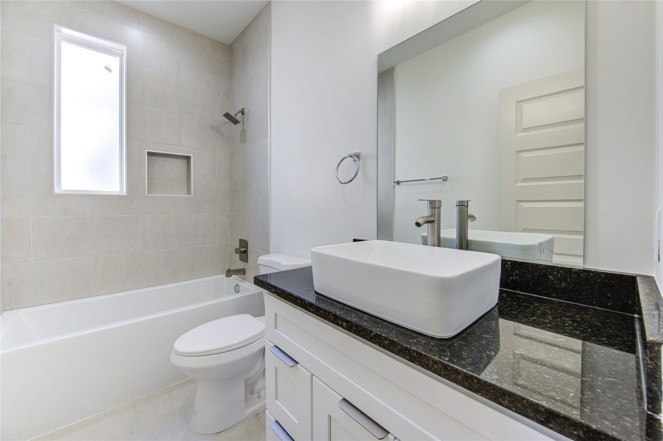 2931 El Fenice Lane Houston, TX 77057 - Photo 23 of 46 a bathroom with a granite countertop sink toilet a mirror and bathtub