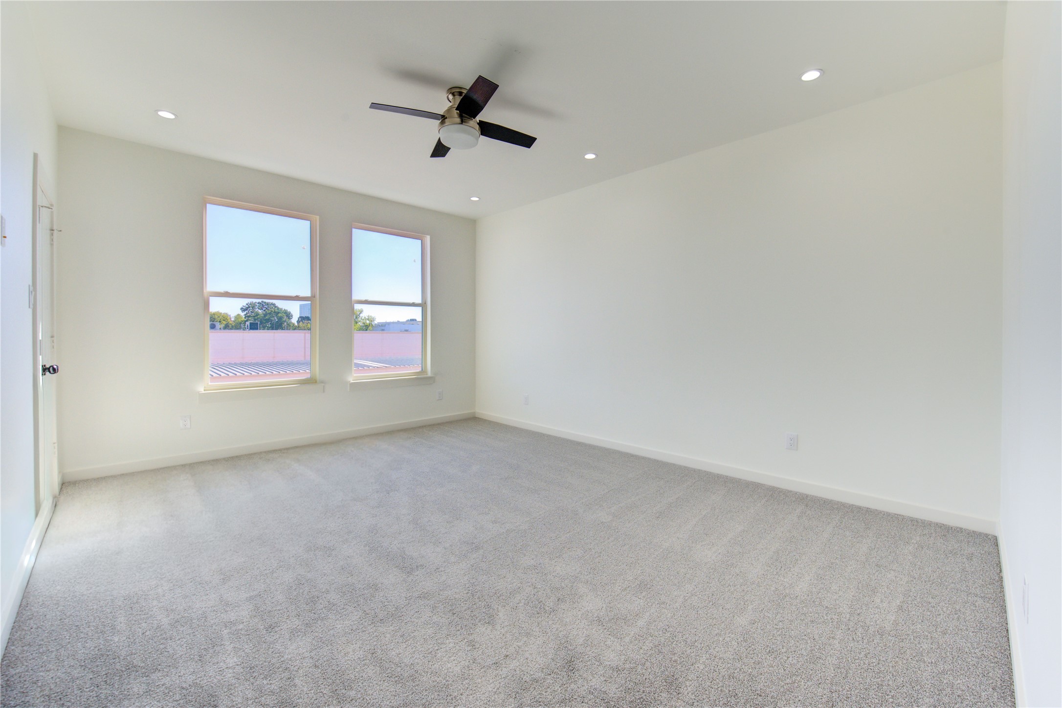 2931 El Fenice Lane Houston, TX 77057 - Photo 24 of 46 an empty room with windows and ceiling fan