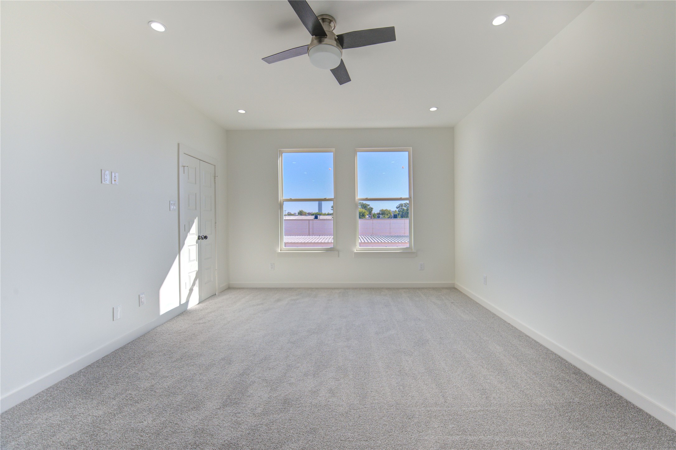 2931 El Fenice Lane Houston, TX 77057 - Photo 27 of 46 an empty room with windows and ceiling fan