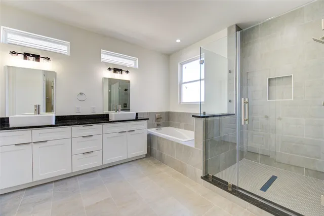 a bathroom with a bathtub and a shower