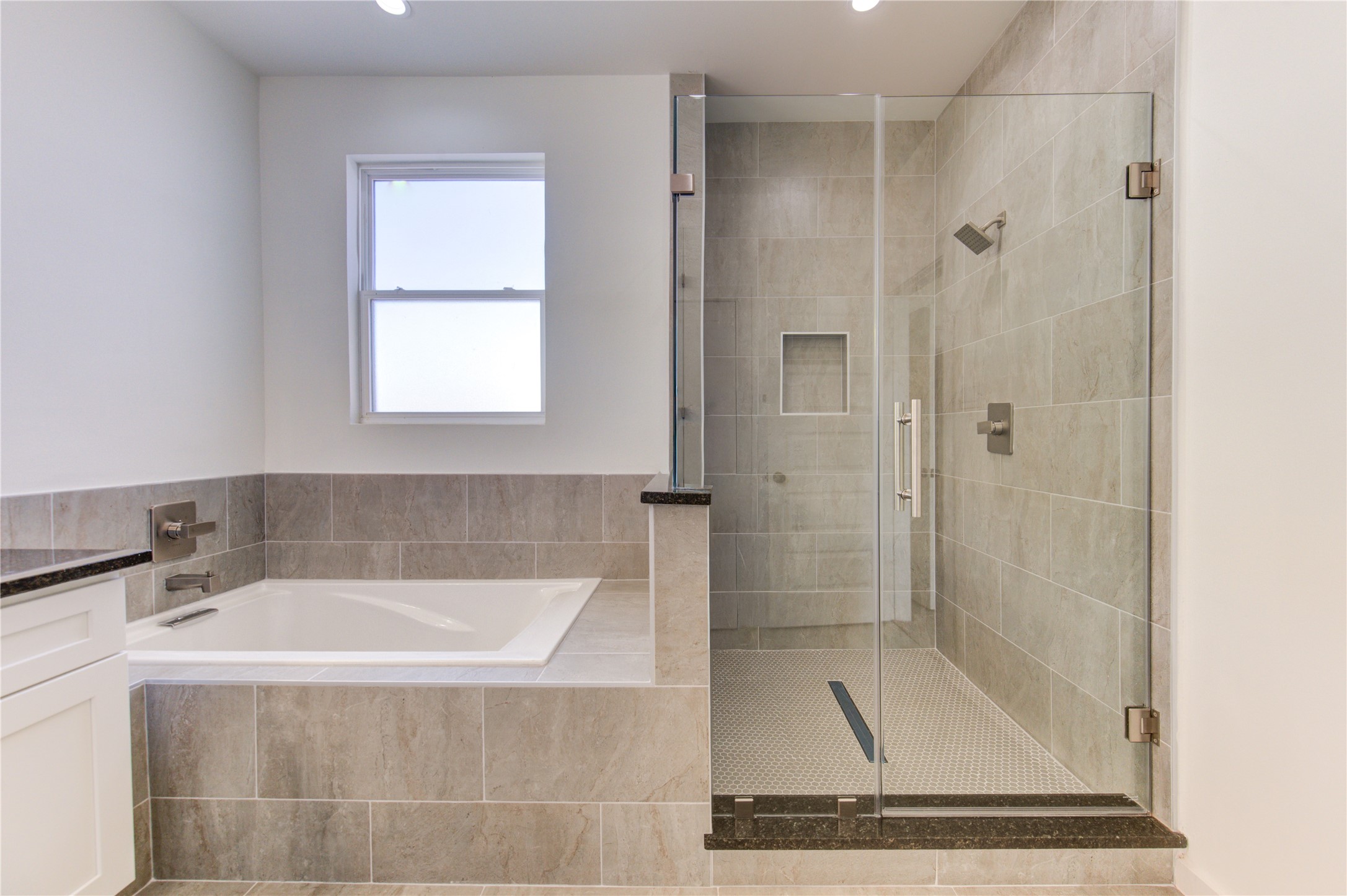 2931 El Fenice Lane Houston, TX 77057 - Photo 30 of 46 a bathroom with a bathtub and a shower