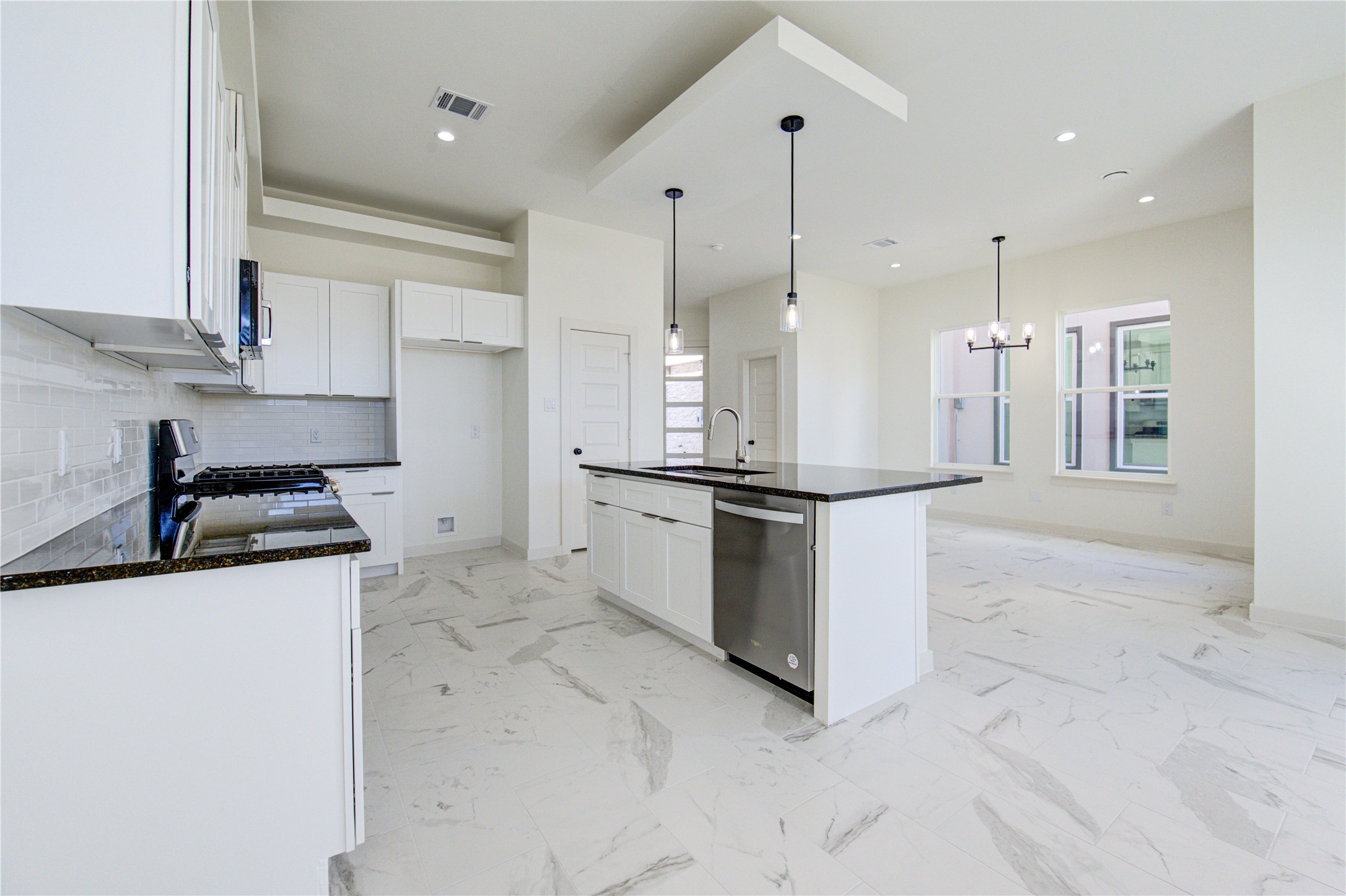 2931 El Fenice Lane Houston, TX 77057 - Photo 3 of 46 a kitchen with stainless steel appliances granite countertop a sink and a refrigerator