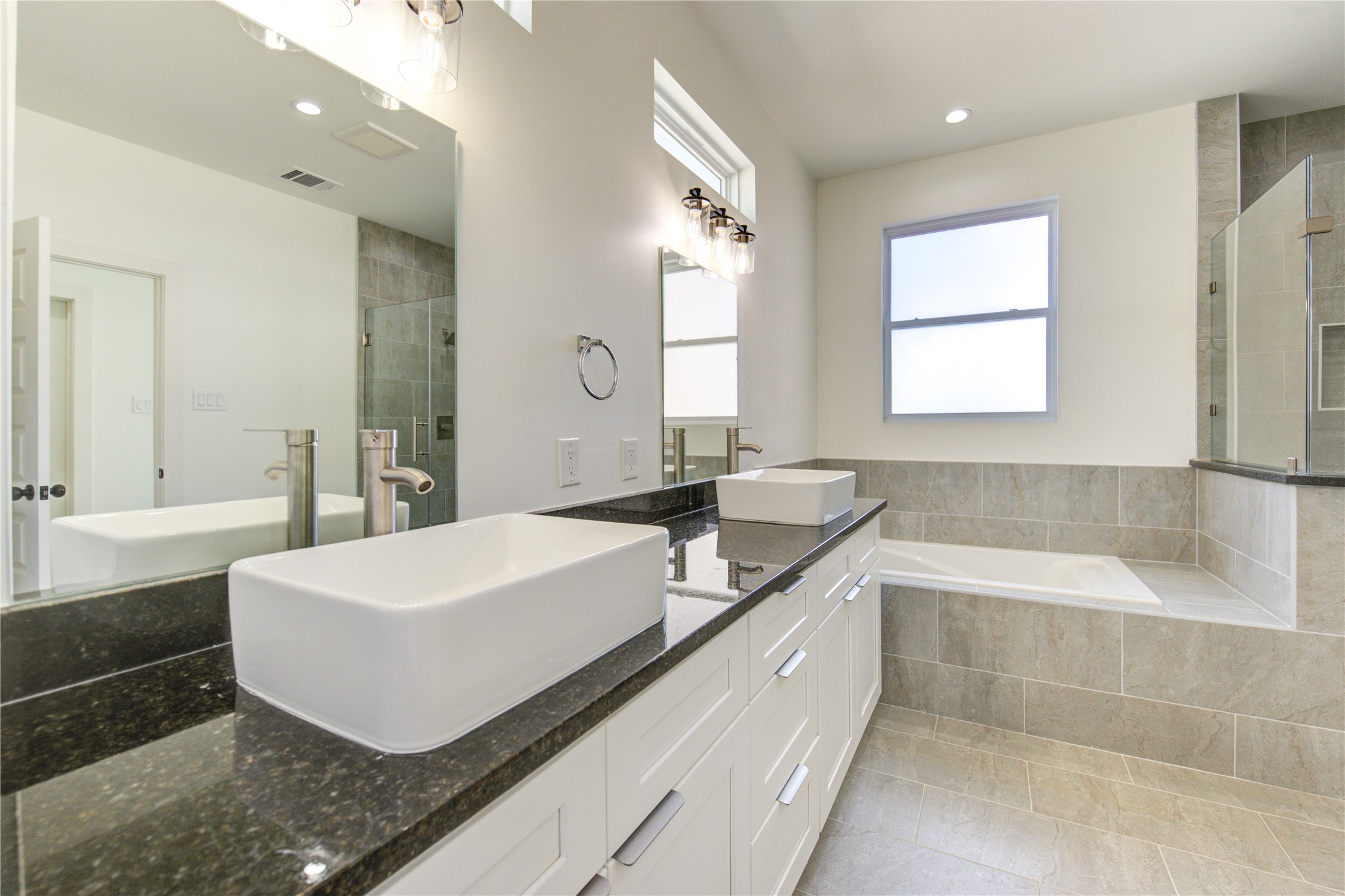 2931 El Fenice Lane Houston, TX 77057 - Photo 32 of 46 a spacious bathroom with a tub sink and mirror