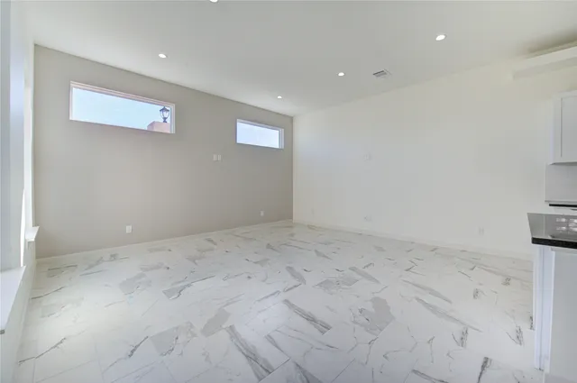 a view of an empty room with windows