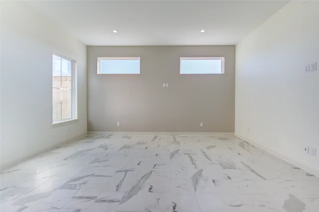 a view of a kitchen with white cabinets and wooden floor