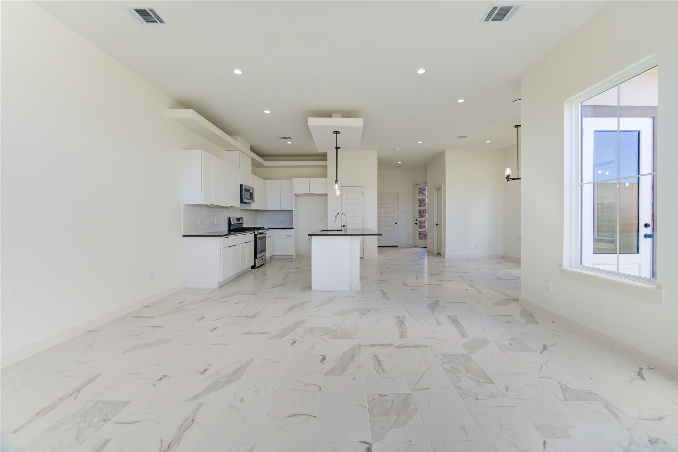 2931 El Fenice Lane Houston, TX 77057 - Photo 41 of 46 a view of a kitchen with white cabinets and wooden floor