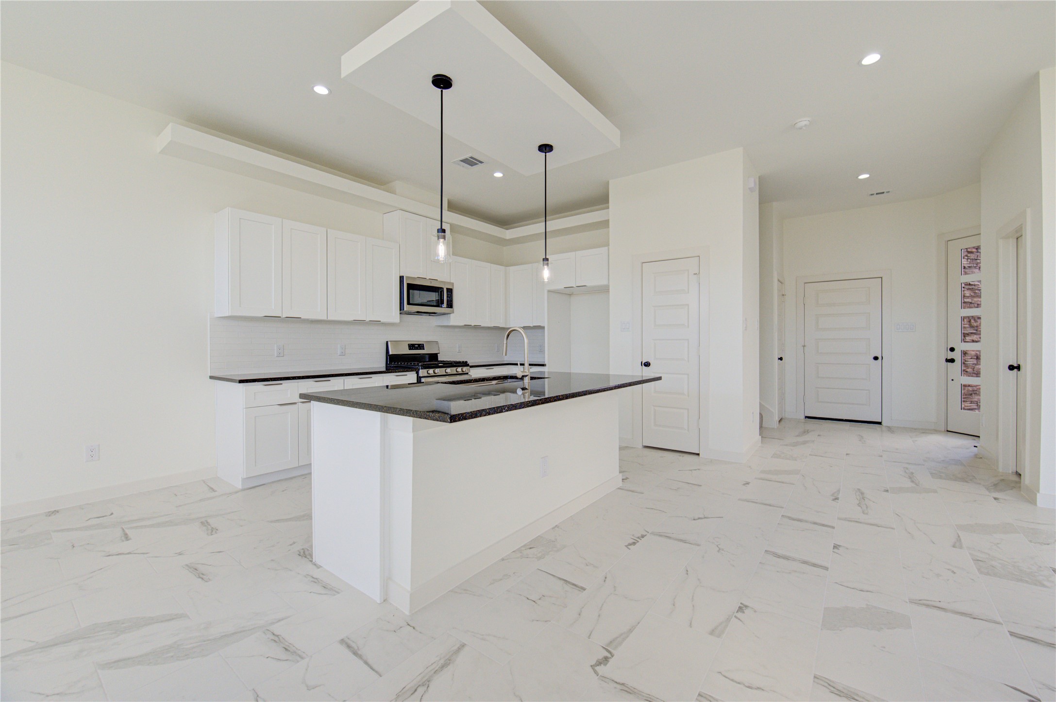 2931 El Fenice Lane Houston, TX 77057 - Photo 5 of 46 a kitchen with granite countertop a stove a sink and a refrigerator
