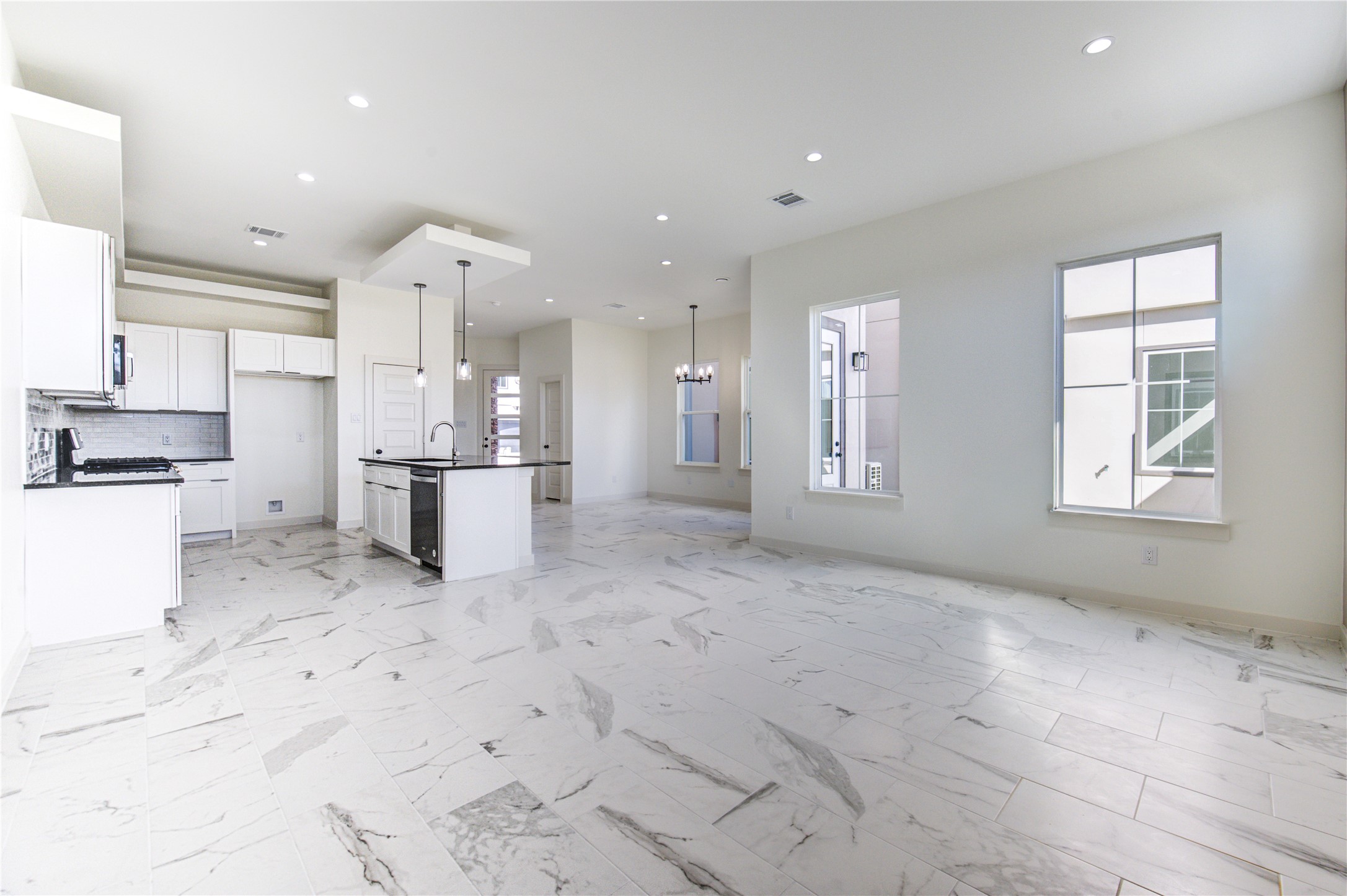 2931 El Fenice Lane Houston, TX 77057 - Photo 6 of 46 a kitchen with stainless steel appliances kitchen island granite countertop a refrigerator and a sink