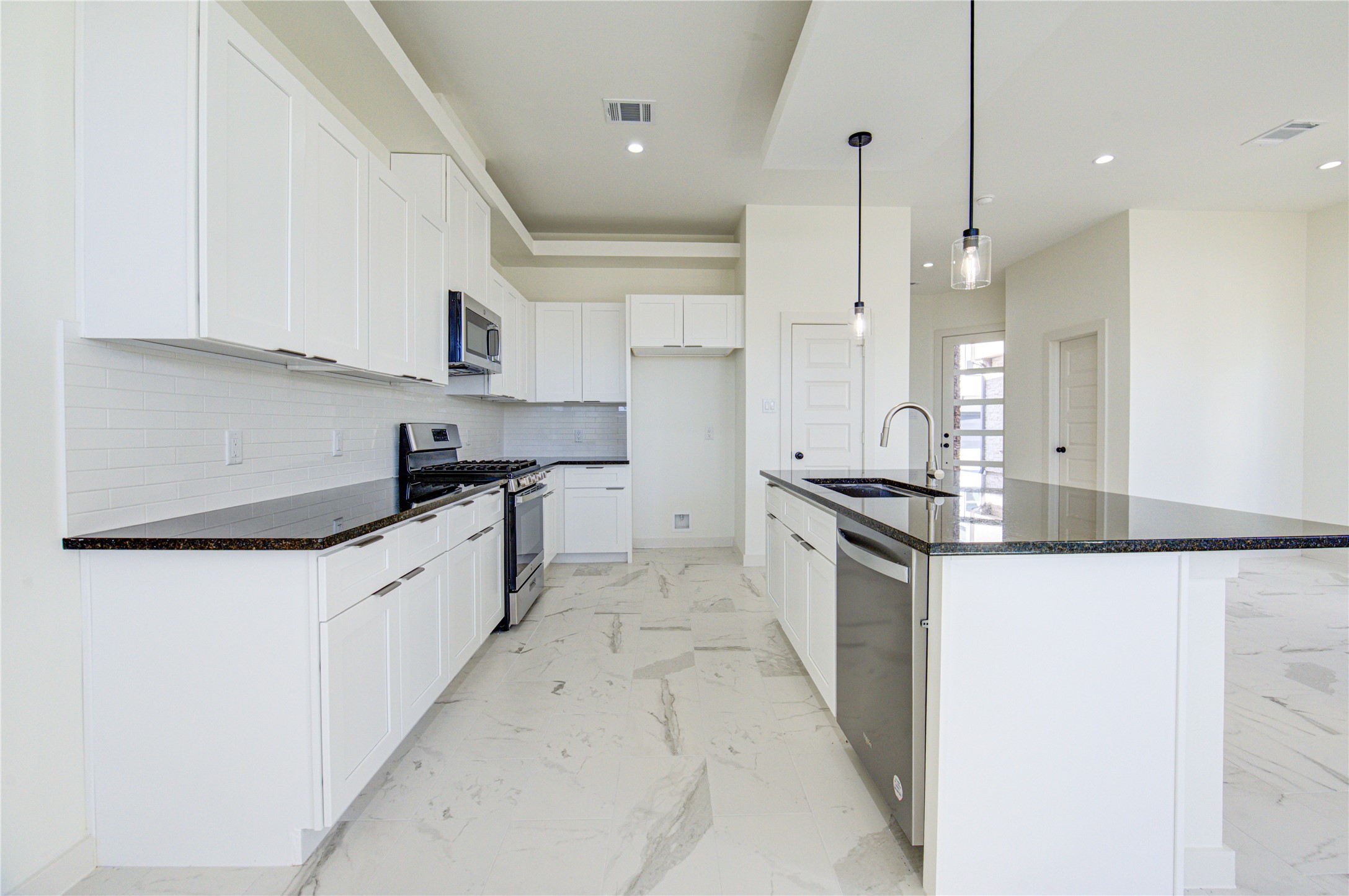 2931 El Fenice Lane Houston, TX 77057 - Photo 8 of 46 a large kitchen with granite countertop a sink a stove and a refrigerator