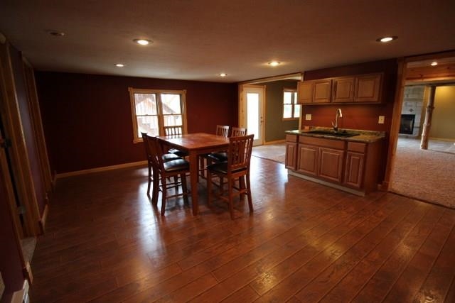 742 North River Road Ridott, IL 61067 - Photo 16 of 25 a kitchen with stainless steel appliances granite countertop wooden floors and stove