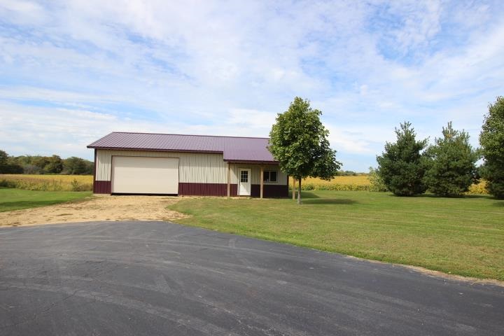 742 North River Road Ridott, IL 61067 - Photo 22 of 25 a front view of a house with a yard and garage