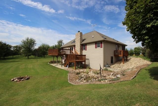 742 North River Road Ridott, IL 61067 - Photo 24 of 25 a view of a house with roof deck and a big yard
