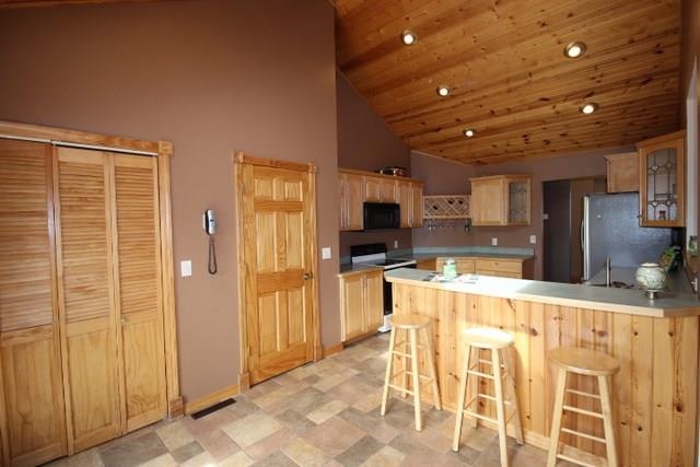 742 North River Road Ridott, IL 61067 - Photo 6 of 25 a large kitchen with stainless steel appliances kitchen island granite countertop a refrigerator and cabinets