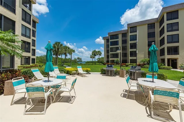 a view of a chairs and table in a patio in front of a building