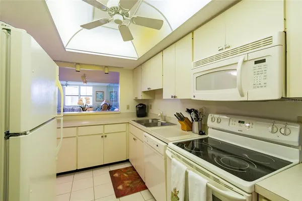 a kitchen with a sink cabinets and window