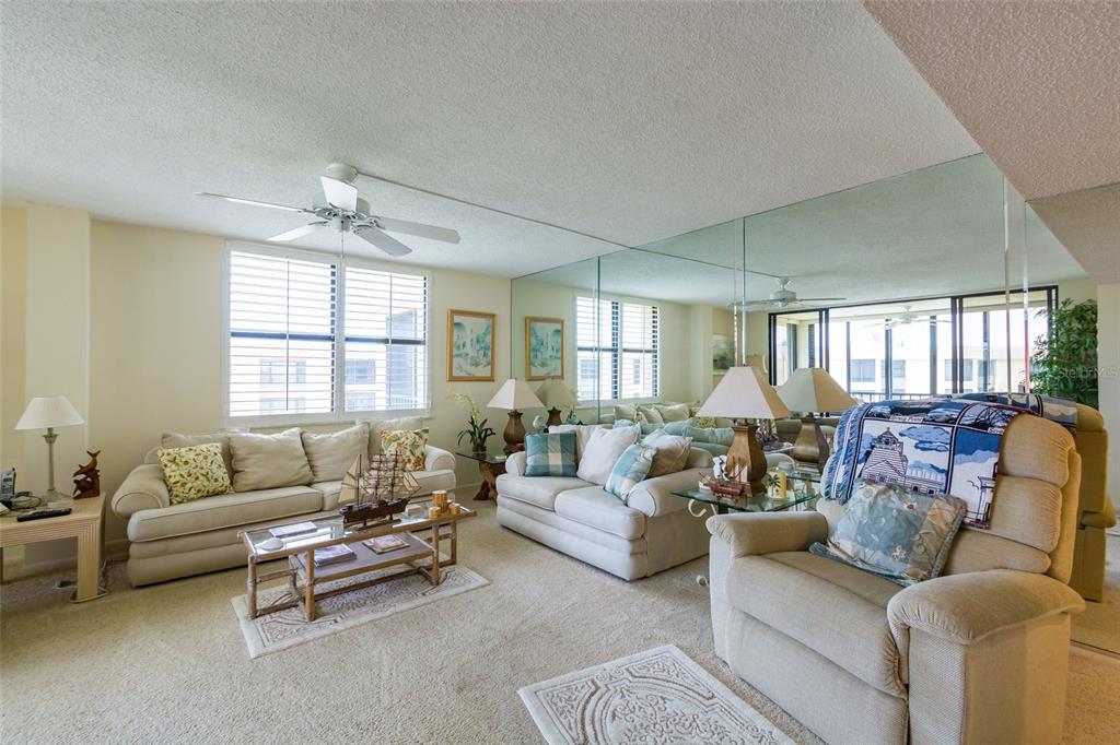 8767 Midnight Pass Road, Unit 506F Sarasota, FL 34242 - Photo 15 of 37 a living room with furniture and a large window