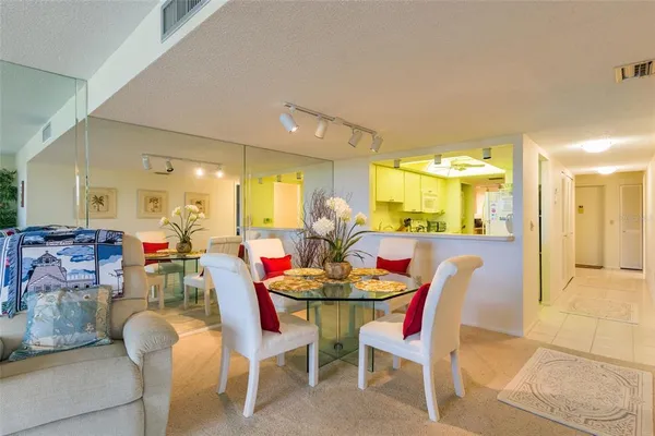 a dining room with furniture and a chandelier
