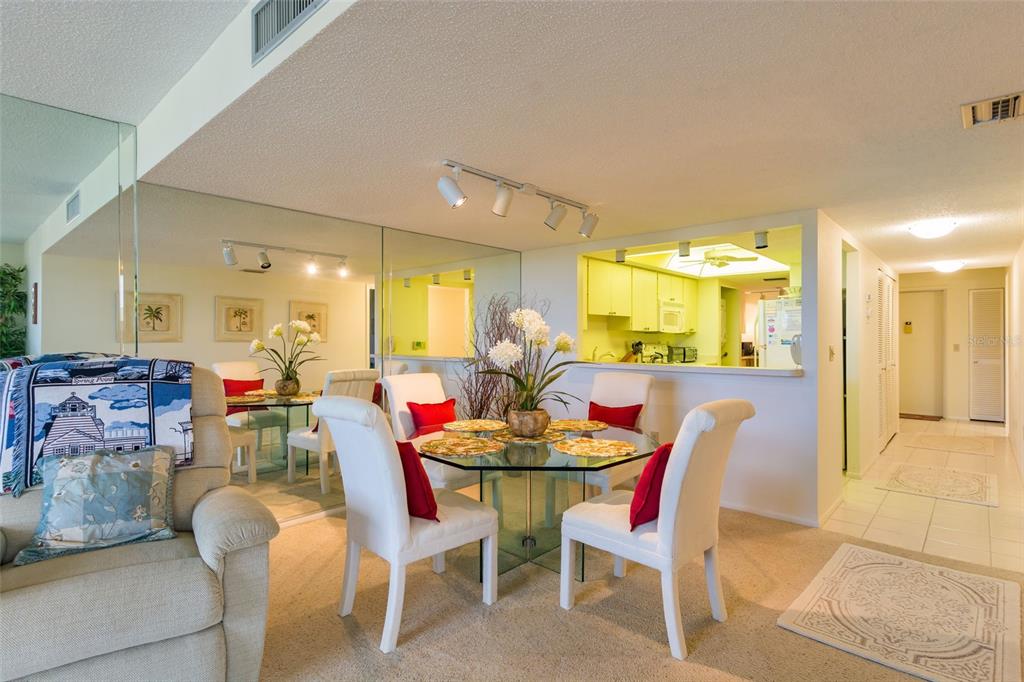 8767 Midnight Pass Road, Unit 506F Sarasota, FL 34242 - Photo 18 of 37 a dining room with furniture and a chandelier