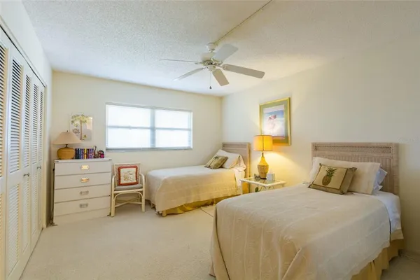 a bedroom with two bed and window