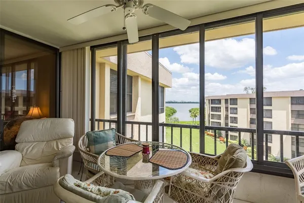 a living room with furniture and a floor to ceiling window
