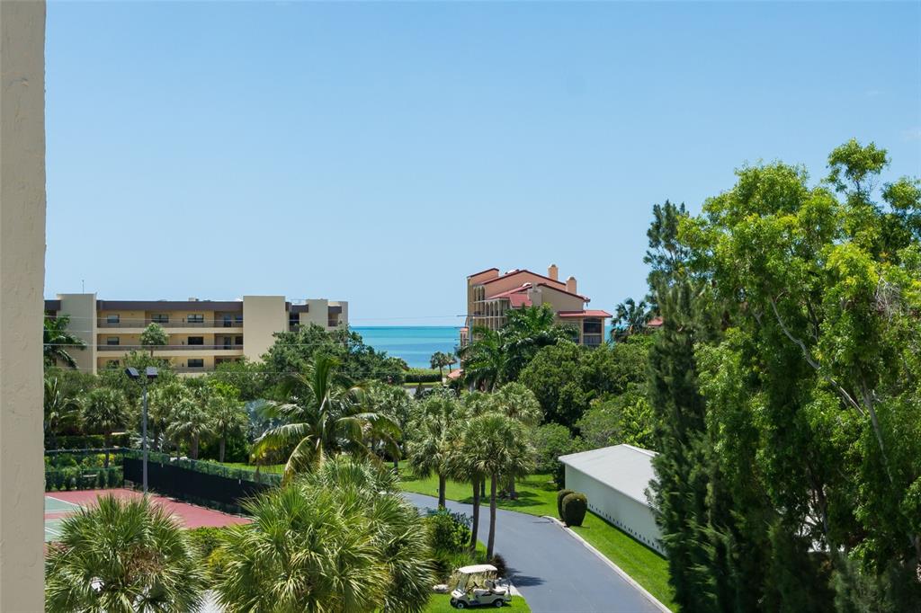 8767 Midnight Pass Road, Unit 506F Sarasota, FL 34242 - Photo 28 of 37 an aerial view of a house with a yard and outdoor seating