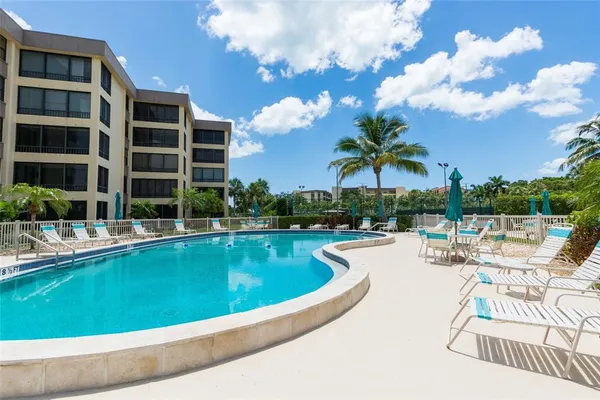 a view of a swimming pool with a lounge chair