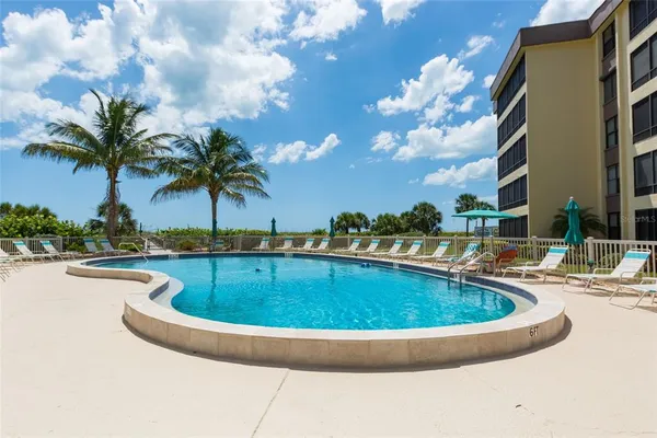 a view of swimming pool with outdoor seating