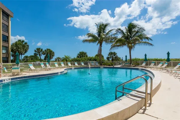 a view of swimming pool with outdoor seating and deck