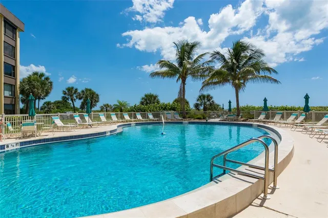 a view of swimming pool with outdoor seating and deck