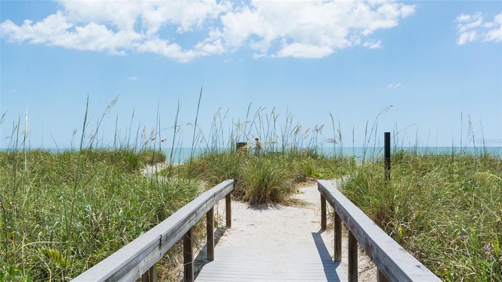 8767 Midnight Pass Road, Unit 506F Sarasota, FL 34242 - Photo 33 of 37 a balcony with trees in front of it