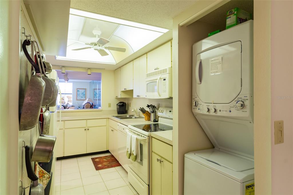 8767 Midnight Pass Road, Unit 506F Sarasota, FL 34242 - Photo 10 of 37 a room with a washing machine and sink