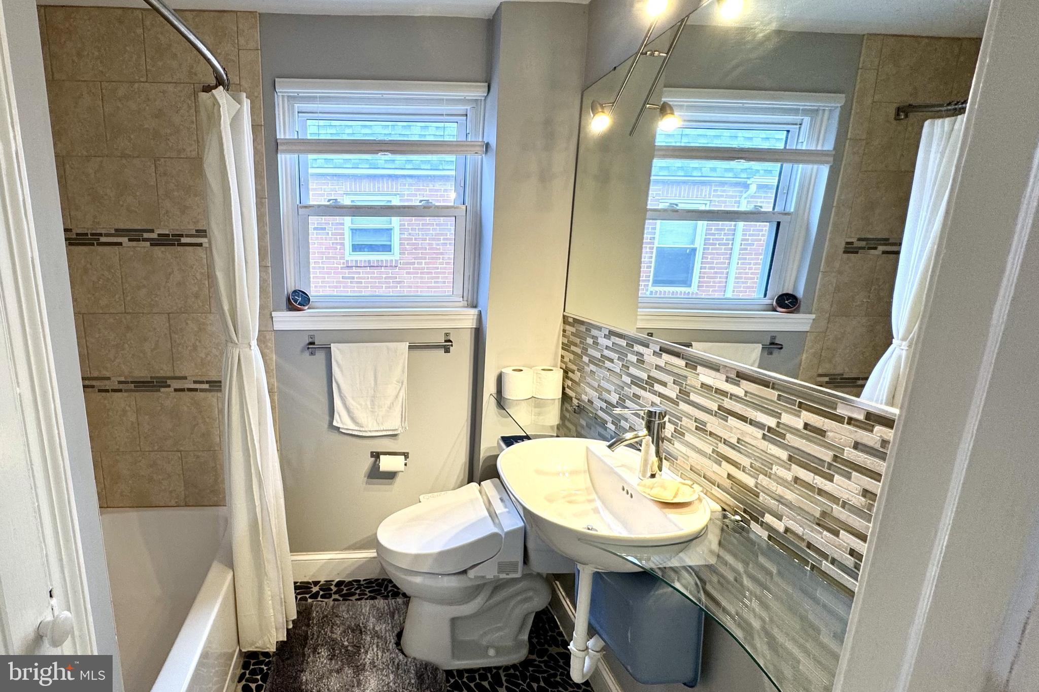 61 Greenhill Road Media, PA 19063 - Photo 22 of 37 a bathroom with a toilet sink and shower