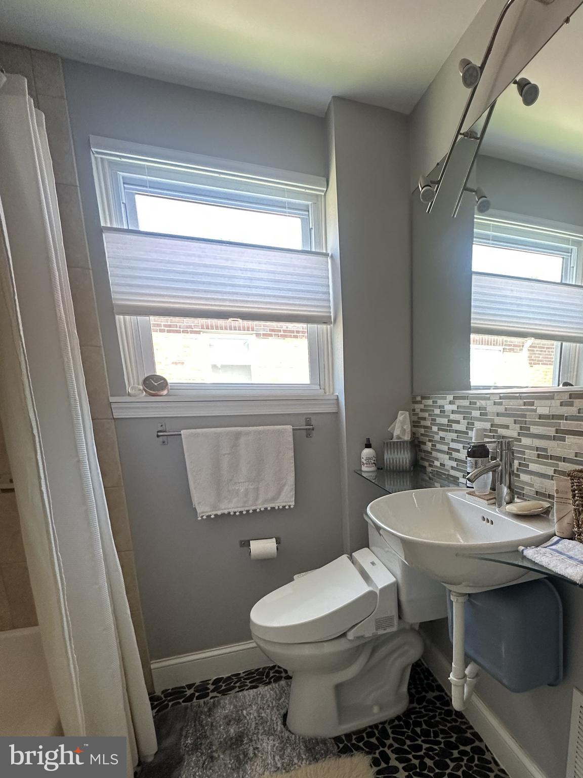 61 Greenhill Road Media, PA 19063 - Photo 23 of 37 a bathroom with a sink toilet and a window
