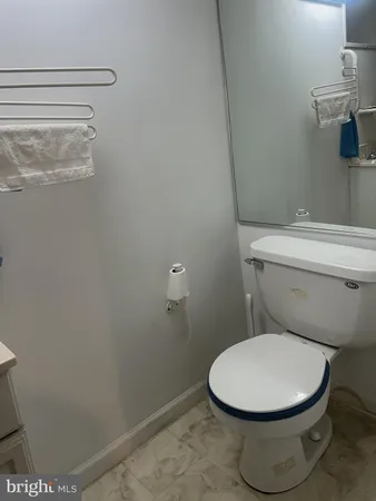 a white toilet sitting next to a shower