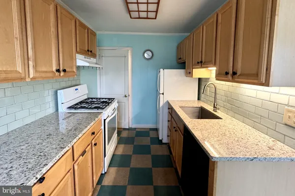 a kitchen with a sink stove and cabinets