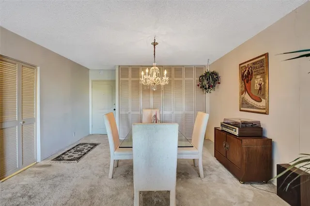 a view of an empty room with furniture and windows