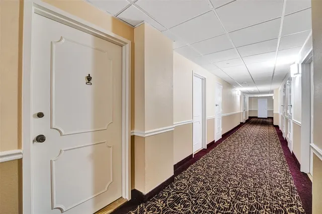 a spacious bedroom with a bed and a large window