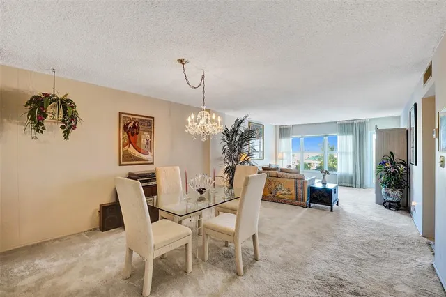 an aerial view of a house with a swimming pool and outdoor seating