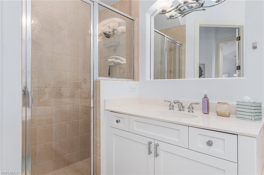12595 Grandezza Circle Estero, FL 33928 - Photo 13 of 33 a bathroom with a sink and a mirror